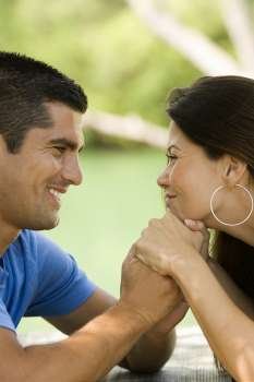 Close-up of a mid adult man and a young woman looking at each other