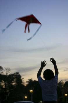 Rear view of a boy flying a kite, Phnom Penh, Cambodia