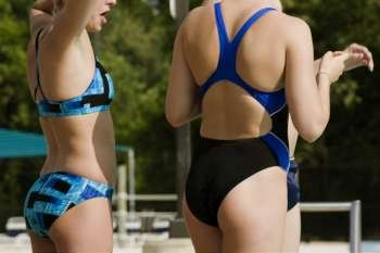 Mid section view of three women in swim suits
