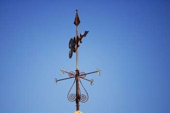 Low angle view of a weather vane on a rooftop
