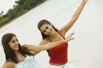 Close-up of two girls dancing on the beach