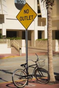 Bicycle parked against an information board, Miami, Florida, USA