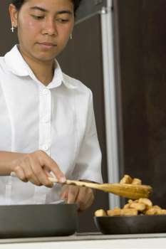Maid preparing food in the kitchen