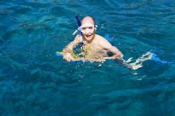 Portrait of a mid adult man snorkeling in the sea