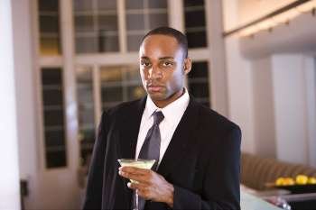 Portrait of a businessman holding a glass of martini