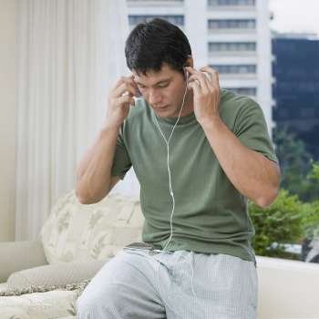 Mid adult man listening to an MP3 player