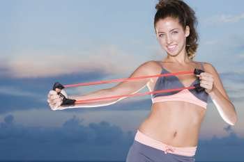 Portrait of a young woman exercising with a resistance band