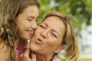 Close-up of a girl kissing her mother