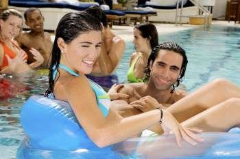 Portrait of a mid adult man and a young woman in a swimming pool