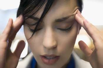 Close-up of a businesswoman suffering from a headache