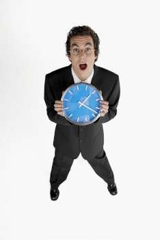 Portrait of a businessman holding a clock