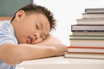 Close-up of a schoolboy napping in a classroom