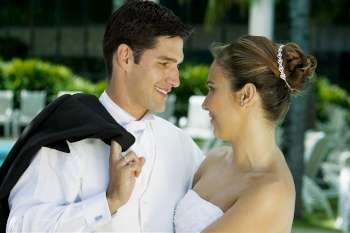 Close-up of a newlywed couple facing each other and smiling