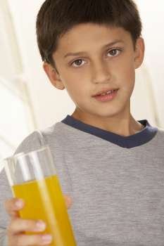 Portrait of a boy holding a glass of juice