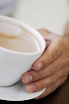 Close-up of a person´s hand holding a cup of coffee