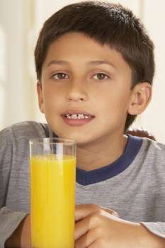 Portrait of a boy in front of a glass of juice