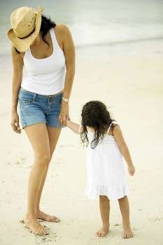 Young woman and her daughter on the beach