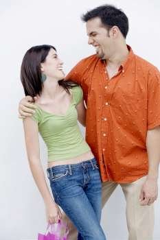 Close-up of a teenage girl and a mid adult man looking at each other