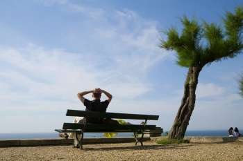 Couple resting on a bench, St. Martin, Biarritz, France