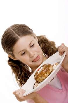 Close-up of a girl holding dessert in a plate