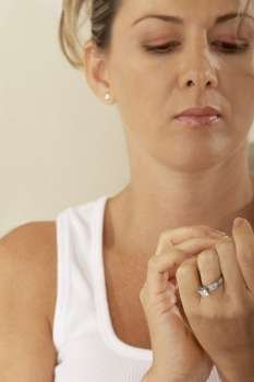 Close-up of a mid adult woman looking at her fingernails