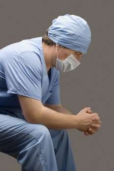 Side profile of a male surgeon thinking