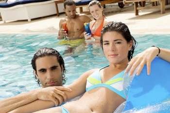 Portrait of two couples in a swimming pool