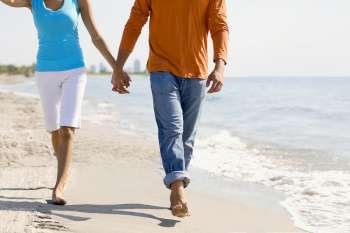 Close-up of a young couple walking on the beach