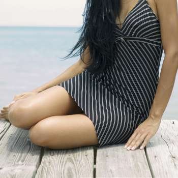 Close-up of a young woman sitting on a pier