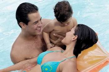 Close-up of parents with their son in a swimming pool
