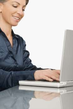 Businesswoman working on a laptop and smiling