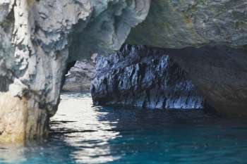 Close-up of a natural arch in a rock formation, Faraglioni Rocks, Capri, Campania, Italy