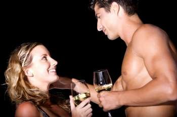 Close-up of a young couple holding wineglasses