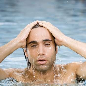 Portrait of a mid adult man swimming in a swimming pool