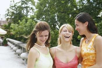 Three young women smiling 