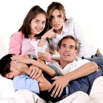Portrait of parents watching television with their son and daughter