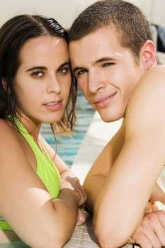 Portrait of a young couple at the poolside