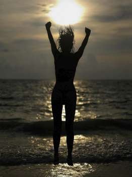Silhouette of a young woman jumping