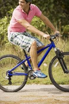 Close-up of a young man riding a bicycle