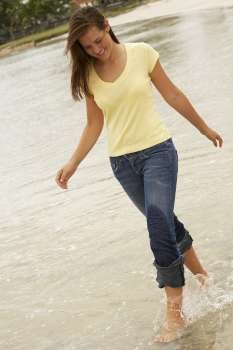 Teenage girl walking in water