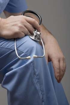 Mid section view of a person holding a stethoscope