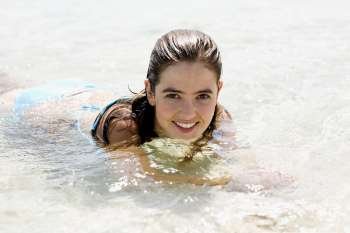Portrait of a young woman swimming in water
