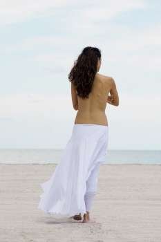 Rear view of a woman walking on the beach