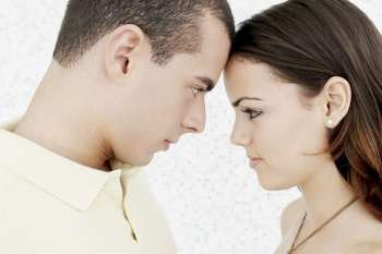 Side profile of a young couple face to face