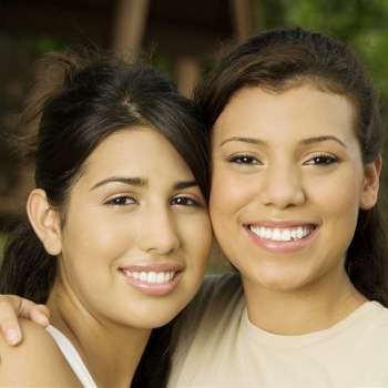 Close-up of two teenage girls smiling