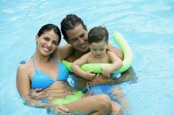 High angle view of parents with their son in a swimming pool