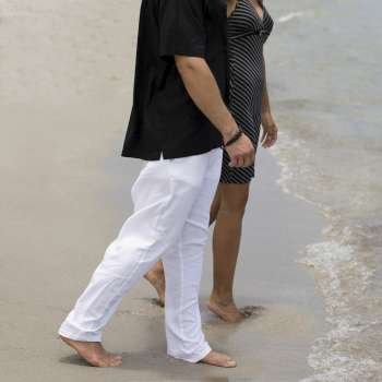 Side profile of a young couple walking on the beach