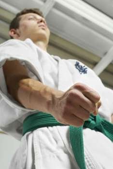 Low angle view of a young man practicing karate
