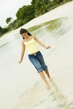 Girl wading in water on the beach