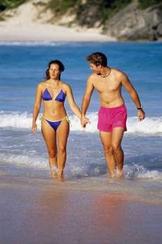 Front view of a couple in swimsuits, Horse-shoe Bay beach, Bermuda